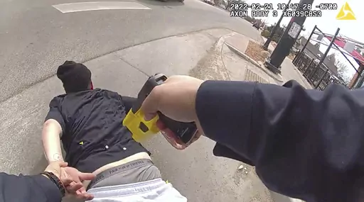 In this frame grab taken from Pueblo Police Department body camera video and provided by attorney Kevin Mehr, representing Cristy Gonzales, Pueblo police Cpl. Bennie Villanueva deploys his Taser into Gonzales' back as she lies on the ground during an arrest, in Pueblo, Colo., Feb. 21, 2022. (Pueblo Police Department via AP)