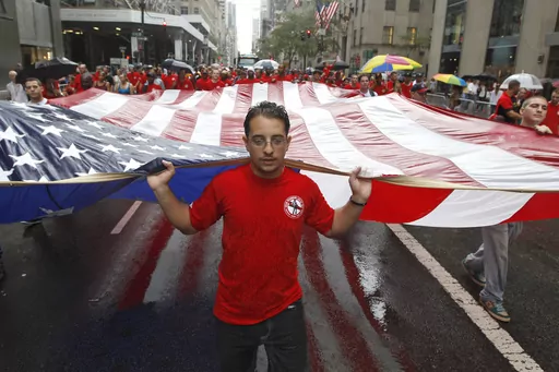 Local 361 iron worker Robert Farula marches up Fifth Ave. carrying an American flag during the Labor Day parade on Sept. 8, 2012 in New York. Labor Day, 2023, is right around the corner. And while many may associate the holiday with major retail sales and end-of summer barbecues, Labor Day's roots in worker-driven organizing feel especially significant this year. (AP Photo/Mary Altaffer, File)