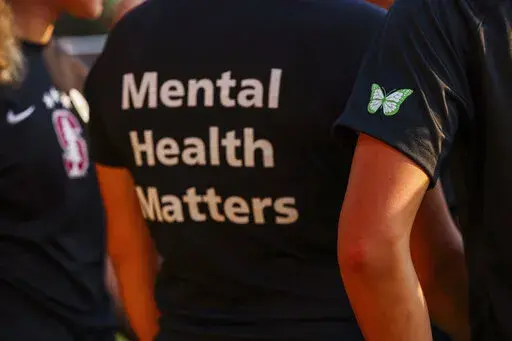 Stanford women's soccer team players wear warmup jerseys with "Mental Health Matters" on their backs as well as a butterfly patch on their sleeves to remember late goalie Katie Meyer, who died by suicide earlier in the year, before an NCAA college soccer match against UCLA, Oct. 14, 2022, in Stanford, Calif. The COVID-19 pandemic took an especially harsh toll on U.S. teen girls’ mental health, with almost 60% reporting feelings of persistent sadness or hopelessness, according to a government s