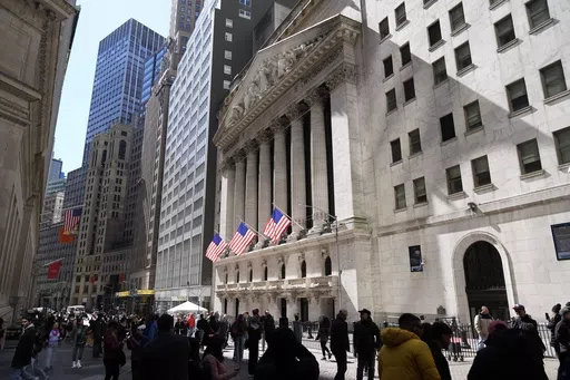 Pedestrians walk past the New York Stock Exchange building on March 25, 2024, in New York. Global shares have mostly declined on Friday, April 5, 2024, as investors looked to a key U.S. jobs report due later in the day to gauge the health of the economy and see what the Federal Reserve might do on interest rates. (AP Photo/Frank Franklin II, File)