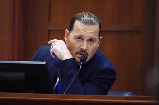 Actor Johnny Depp testifies in the courtroom at the Fairfax County Circuit Courthouse in Fairfax, Va., Monday, April 25, 2022. Depp sued his ex-wife Amber Heard for libel in Fairfax County Circuit Court after she wrote an op-ed piece in The Washington Post in 2018 referring to herself as a "public figure representing domestic abuse." (AP Photo/Steve Helber, Pool)