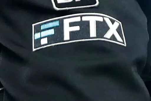 The FTX logo appears on home plate umpire Jansen Visconti's jacket at a baseball game with the Minnesota Twins on Tuesday, Sept. 27, 2022, in Minneapolis. The new CEO of the collapse cryptocurrency trading firm FTX, who oversaw Enron’s bankruptcy, said, Thursday, Nov. 17,  he has never seen such a “complete failure” of corporate control. John Ray III, in a filing with the U.S. bankruptcy court for the district of Delaware, said there was a “complete absence of trustworthy financial infor