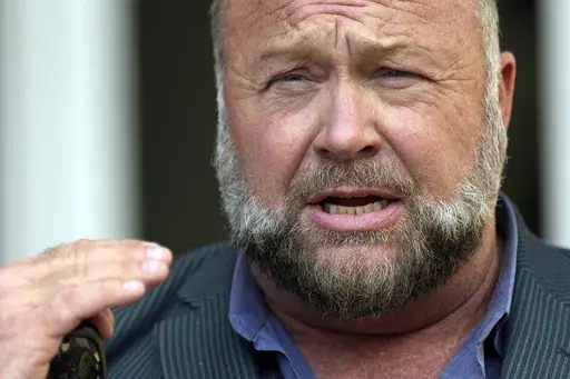 Right-wing conspiracy theorist Alex Jones speaks outside the federal courthouse after a bankruptcy hearing Friday, June 14, 2024, in Houston. (AP Photo/David J. Phillip, File)