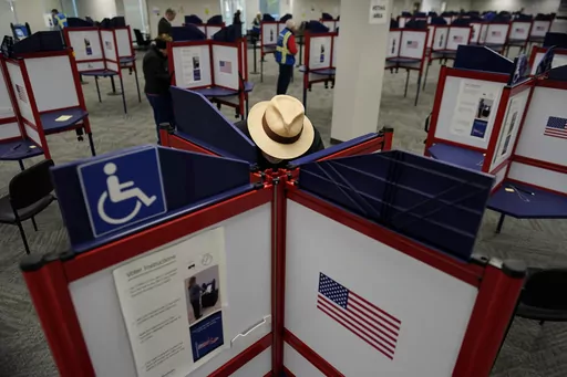 Rod Sommer stands in a partitioned booth and fills out his ballot during early in-person voting at the Hamilton County Board of Elections in Cincinnati, Wednesday, Oct. 11, 2023. (AP Photo/Carolyn Kaster, File)