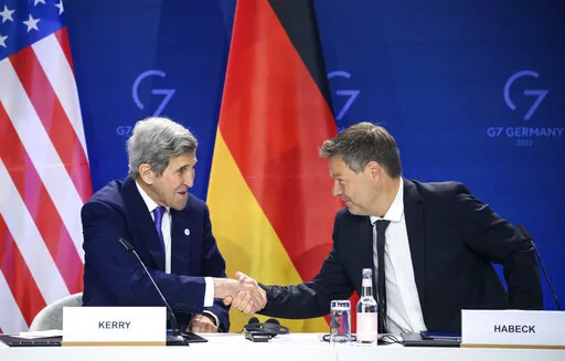 German Economy and Climate Minister Robert Habeck, right, and John Kerry, left, Special Envoy of the U.S. President for Climate, shake hands after they signed a declaration of intent to establish a German-American climate and energy partnership between the United States of America and Germany at the meeting of the G7 Ministers for Climate, Energy and Environment in Berlin, Germany, Monday, May. 27, 2022. (Bernd von Jutrczenka/dpa/dpa via AP)