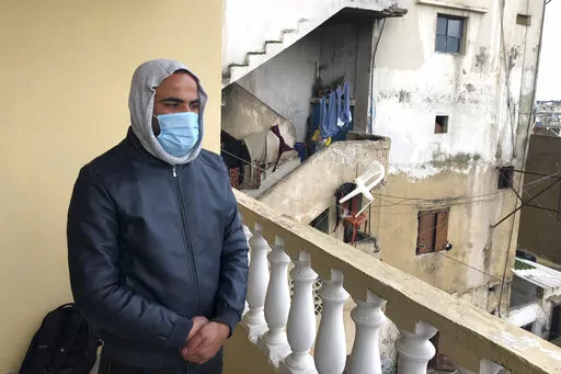 Mahmoud Seif, whose brother Bakr, was killed in Iraq last week speaks during an interview with The Associated Press, on the balcony of his apartment in the northern Lebanese village of Wadi Nahleh, Lebanon, Wednesday, Feb. 2, 2022.  As Lebanon slid deeper into economic misery over recent months, dozens of young men have disappeared from the country’s marginalized north and later surfaced in Iraq, where they are believed to have joined the Islamic State group. The migration has stoked fears of 