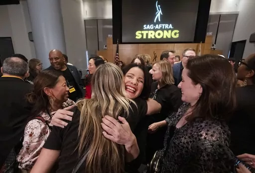 SAG-AFTRA President Fran Drescher, hugs a member of the TV/Theatrical Negotiating Committee member in celebration after a news conference at the SAG-AFTRA offices in Los Angeles on Friday, Nov. 10, 2023. (AP Photo/Richard Vogel)