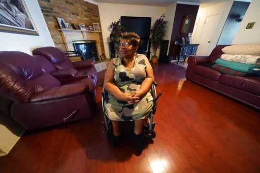 India Scott sits in the living room of her home in New Orleans, Monday, Oct. 10, 2022. Activists, advocates, researchers and people living with disabilities say not enough is being done to include disabled people in climate action planning and policy, or disaster relief and recovery efforts. (AP Photo/Gerald Herbert)