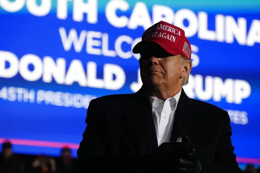 Former President Donald Trump arrives at a rally, Saturday, March 12, 2022, in Florence, S.C. Trump has endorsed two Republicans mounting primary challenges to sitting House members who have been critical of him. (AP Photo/Meg Kinnard)