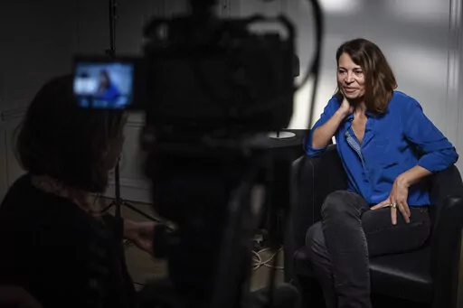 Helene Devynck speaks during an interview with the Associated Press, Monday, Oct. 17, 2022 in Paris. Author Helene Devynck is among dozens of women who have spoken out recently to accuse France's most famous TV presenter, Patrick Poivre d'Arvor, of rape, sexual abuse or harassment occurring from 1981 to 2018. (AP Photo/Aurelien Morissard)
