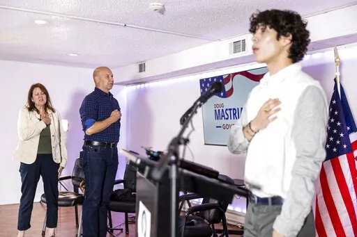 State Sen. Doug Mastriano, Republican gubernatorial candidate, stands as the national anthem is sung during a campaign event at the Deja Vu Social Club in Philadelphia, Pa., Friday, Sept., 30, 2022. In one of the most closely watched races in one of the most contested battleground states, both candidates for governor in Pennsylvania bring religion into their campaigns. (Tyger Williams/The Philadelphia Inquirer via AP, File)