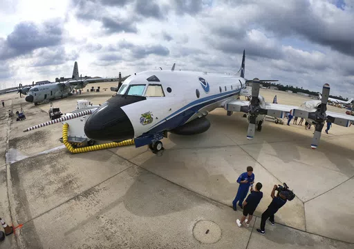 One of the National Oceanic and Atmospheric Administration's (NOAA) WP-3D Orion aircraft sits on the tarmac, with the U.S. Air Force Reserve 53rd Weather Reconnaissance Squadron's WC-130J, far left, during a stop at Orlando Sanford International Airport, in Sanford, Fla., Friday, May 10, 2024. The planes are "Hurricane Hunters" — flying science labs that navigates into the heart of tropical cyclones— collecting real-time storm data. (Joe Burbank /Orlando Sentinel via AP)