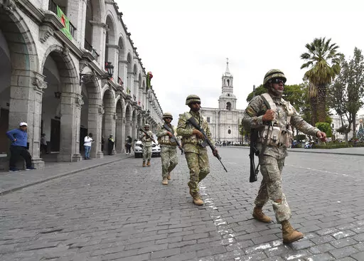 Soldiers patrol in Arequipa, Peru, Wednesday, Dec. 14, 2022. Peru’s new government declared a 30-day national emergency on Wednesday amid violent protests following the ouster of President Pedro Castillo, suspending the rights of “personal security and freedom” across the Andean nation. (AP Photo/Jose Sotomayor)