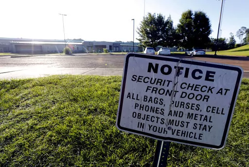 A security notice is posted outside the Hinds County Detention Center in Raymond, Miss., on June 12, 2015. A federal judge has issued a civil contempt order over conditions at the detention center.  U.S. District Judge Carlton Reeves wrote Friday, Feb. 4, 2022, that Hinds County officials have failed to fix problems in the jail that has experienced violence and lax security.  (AP Photo/Rogelio V. Solis, File)