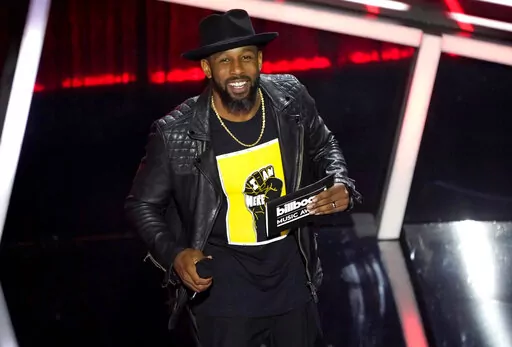 Stephen "tWitch" Boss presents the award for top Latin artist at the Billboard Music Awards in Los Angeles on Oct. 14, 2020. (AP Photo/Chris Pizzello, File)