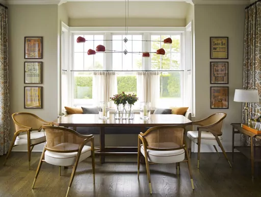 This image provided by Mendelson Group shows designer Gideon Mendelson's home in Sagaponack, New York. Mendelson framed some inexpensive yet eye-catching vintage deli signs for a playful element to the dining room. "Slow decorating" embraces a more deliberate approach that prioritizes a personal connection to the stuff we live with. (Eric Piasecki/OTTO via AP)