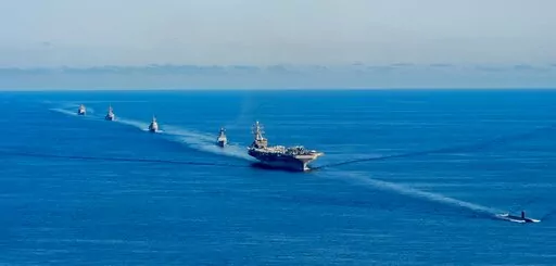 In this photo provided by the South Korea Defense Ministry, the USS Ronald Reagan aircraft carrier, second from right, participates in a joint anti-submarine drill among South Korea, the United States and Japan in waters off South Korea's eastern coast in South Korea, Friday, Sept. 30, 2022. South Korea, U.S. and Japanese warships launched their first trilateral anti-submarine drills in five years on Friday, after North Korea renewed missile tests this week in an apparent response to bilateral t