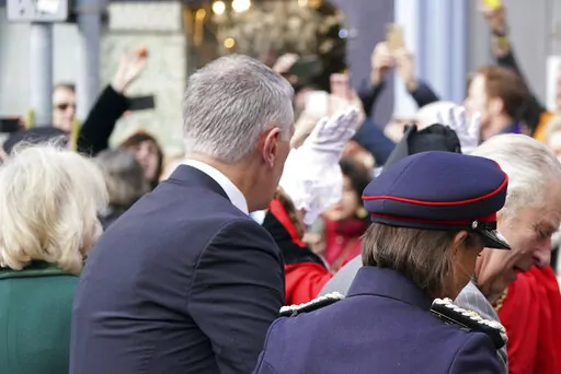 A protester, top left, throws eggs at King Charles III, right, and the Queen Consort, left, as they arrive for  a ceremony at Micklegate Bar, where the Sovereign is traditionally welcomed to the city, in York, England, Wednesday Nov. 9, 2022. (Jacob King/PA via AP)