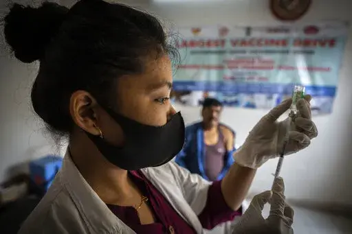 FILE- A nurse prepares to administer vaccine for COVID-19 at a private vaccination center in Gauhati, India, April 10, 2022. The quickly changing coronavirus has spawned yet another super contagious omicron mutant that's worrying scientists as it gains ground in India and pops up in numerous other countries, including the United States. Scientists say the variant, which is called BA.2.75, may be able to spread rapidly and get around immunity from vaccines and previous infection. (AP Photo/Anupam