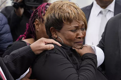 Bettersten Wade, mother of Dexter Wade, who died after being hit by a Jackson, Miss., police SUV driven by an off-duty officer, cries after her son's body is exhumed from a pauper's cemetery in Raymond, Miss., Nov. 13, 2023. A judge on Friday, May 31, 2024, ordered the enforcement of a lawsuit settlement between the city of Jackson and the family of 62-year-old George Robinson, who died after police officers pulled him from a car while searching for a murder suspect in 2019. Wade is Robinson's s