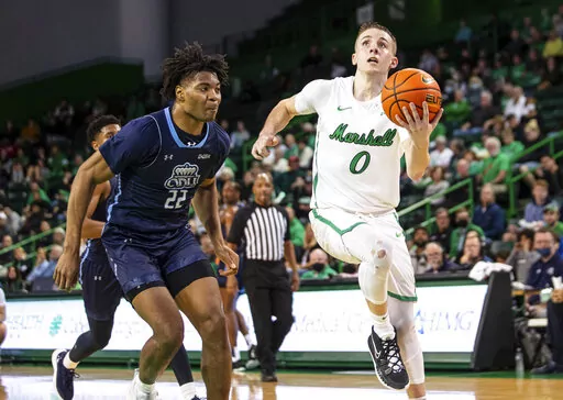Marshall's Andrew Taylor (0) drives to the rim against Old Dominion's Kalu Ezikpe (22) during an NCAA men's basketball game on Thursday, Feb. 17, 2022, at the Cam Henderson Center in Huntington./The Herald-Dispatch via AP)