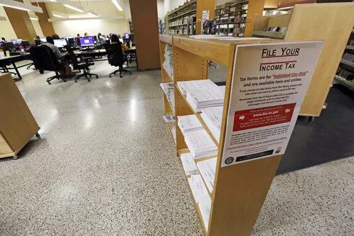 In this Feb. 15, 2018, photo, state and federal tax forms are available at the Eudora Welty Library in Jackson, Miss., for filers who want to do their own taxes. The board of the Mississippi Department of Archives and History met Friday, April 19, 2024, and approved a demolition permit for the library, which had closed after falling into disrepair. (AP Photo/Rogelio V. Solis, File)