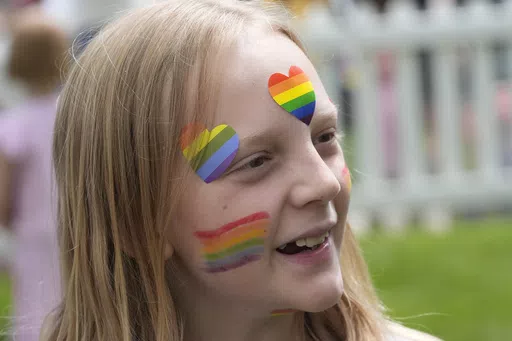 Bonneville Elementary School 5th grader Graham Beeton, is interviewed during a block party supporting trans and non binary students and staff Monday, April 29, 2024, in Salt Lake City. Utah will become the latest state to implement restrictions for transgender people using school bathrooms and locker rooms in public schools and government-owned buildings when key components of a law passed by the Republican controlled Legislature take effect May 1. (AP Photo/Rick Bowmer)