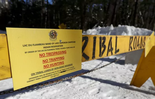 A roadblock is seen along Center Sugarbush Lane on Feb. 8, 2023, at Lac du Flambeau town hall in Lac du Flambeau, Wis. Officials with the town of Lac du Flambeau on Saturday, March, 11, 2023, accepted the Lac du Flambeau tribe’s offer to remove barricades blocking the roads for 90 days in exchange for $60,000 as negotiations continue for a more permanent solution, the Green Bay Press-Gazette reported. (Tork Mason/The Post-Crescent via AP)