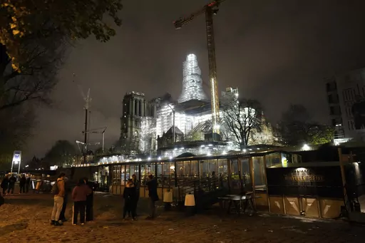 Notre-Dame de Paris cathedral is seen with its spire surrounded by scaffolding Tuesday, Dec. 5, 2023 in Paris. The restoration of Notre Dame hits a milestone Friday, Dec. 8, 2023: one year until the cathedral reopens its huge doors to the public. (AP Photo/Thibault Camus)