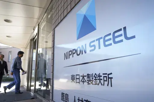 A staff enters doorway next to Nippon Steel logo at the company's Kashima Plant in Kashima, Japan on Friday, Dec. 6, 2024. (AP Photo/Ayaka McGill, File)