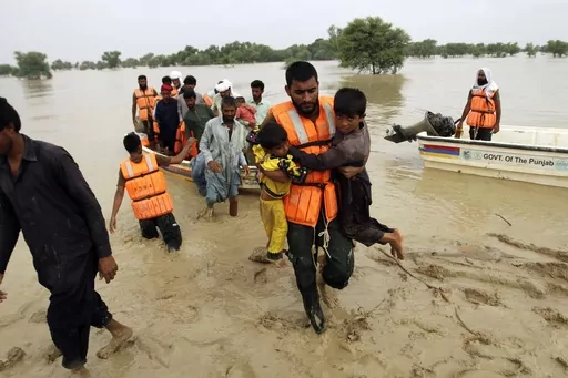 Army troops evacuate people from a flood-hit area in Rajanpur, district of Punjab, Pakistan, Aug. 27, 2022. The flooding in Pakistan killed at least 1,700 people, destroyed millions of homes, wiped out swathes of farmland, and caused billions of dollars in economic losses. (AP Photo/Asim Tanveer, File)