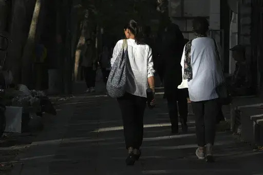 Iranian women not wearing their mandatory headscarf, or hijab, walk in Tehran, Iran, Saturday, Aug. 5, 2023. (AP Photo/Vahid Salemi, File)