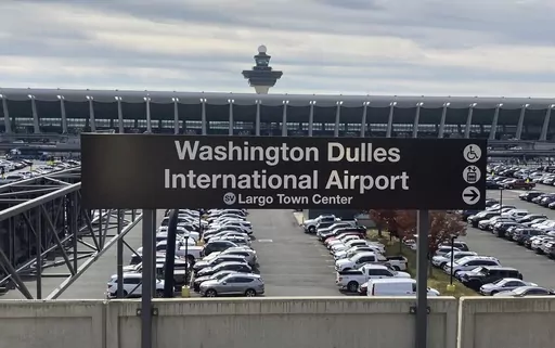 The Metrorail station at Dulles International Airport is seen on Nov. 2, 2022, in Chantilly, Va., with the terminal in the background. Normal operations at airports in the Washington, D.C., area resumed about an hour after they were suspended Sunday evening, June 25, 2023, because of a problem at a major air traffic control facility, the Federal Aviation Administration said. (AP Photo/Matthew Barakat, File)