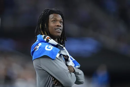 Detroit Lions wide receiver Jameson Williams watches from the bench area against the Jacksonville Jaguars during an preseason NFL football game in Detroit, Saturday, Aug. 19, 2023. Detroit wide receiver Jameson Williams and Tennessee right tackle Nicholas Petit-Frere start their six-game suspensions for betting at work Tuesday at the NFL's final roster cutdown deadline. At least they'll be able to rejoin their teams this season. (AP Photo/Paul Sancya, File)
