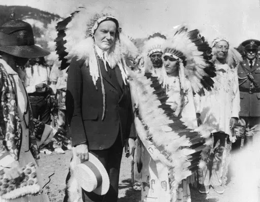 U.S. President Calvin Coolidge wears a Native American headdress of the Sioux tribe as he is adopted as Chief Leading Eagle and first white chief of the tribe at the celebration of the 51st anniversary of the settlement of Deadwood, South Dakota, in 1927. Coolidge signed the Indian Citizenship Act of 1924. (AP Photo/File)