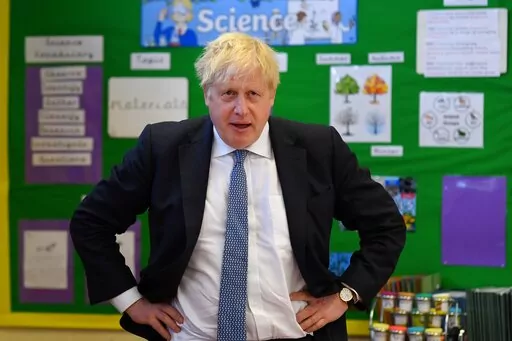 Britain's Prime Minister Boris Johnson visits the Field End Infant school, in South Ruislip, London, Friday May 6, 2022, following the local government elections. Britain’s governing Conservatives have suffered local election losses in their few London strongholds. Voting held Thursday for thousands of seats on more than 200 local councils decided who will oversee garbage collection and the filling of potholes, but were also seen as an important barometer of public opinion ahead of the next na