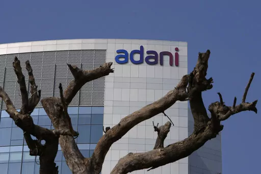 FILE- Dried branches of a tree stand outside Adani Corporate House in Ahmedabad, India, Friday, Jan. 27, 2023. The closely watched $2.5 billion share sale launched by Asia’s richest man, Gautam Adani, was fully subscribed on Tuesday. The share sale and its success were seen as a crucial test of investor confidence in Adani, whose sprawling empire shed tens of billions of dollars within a week after Hindenburg Research accused the conglomerate of stock market manipulation and fraud. (AP Photo/A