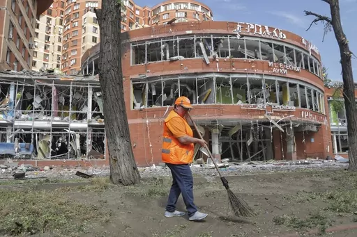 Municipal workers clean at the scene of a nightly Russian rocket attack in Odesa, Ukraine, Wednesday, June 14, 2023. Officials say Russian forces have fired cruise missiles at the southern Ukrainian city of Odesa overnight and shelling has destroyed homes in the eastern Donetsk region, killing at least six people and injuring more than a dozen others.(AP Photo/Nina Lyashonok)