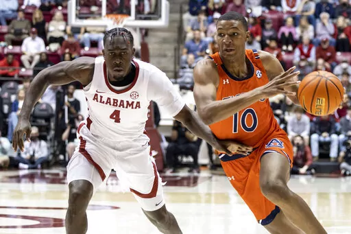 Auburn forward Jabari Smith (10) works around Alabama forward Juwan Gary (4) during the first half of an NCAA college basketball game, Tuesday, Jan. 11, 2022, in Tuscaloosa, Ala. (AP Photo/Vasha Hunt)