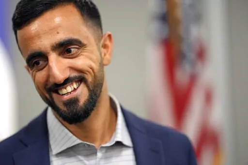 Abdul Wasi Safi smiles after a news conference Friday, Jan. 27, 2023, in Houston. Wasi Safi, an intelligence officer for the Afghan National Security Forces who fled Afghanistan following the withdrawal of U.S. forces, was freed this week and reunited with his brother after spending months in immigration detention. (AP Photo/David J. Phillip)