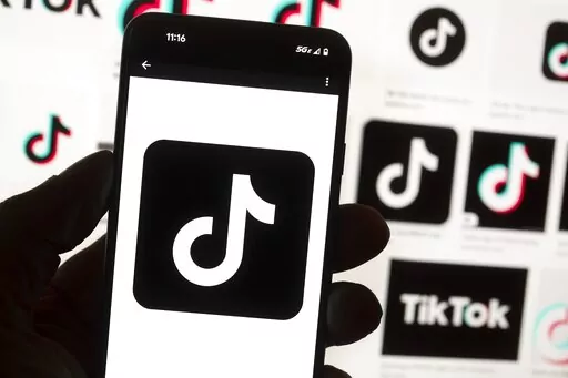 The TikTok logo is seen on a cellphone on Oct. 14, 2022, in Boston. TikTok says every account held by a user under the age of 18 will automatically be set to a 60-minute daily screen time limit in the coming weeks amid growing concerns about the app's security. (AP Photo/Michael Dwyer, File)