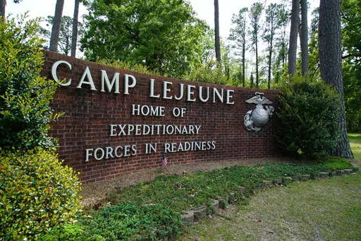 Signage stands on the main gate to Camp Lejeune Marine Base outside Jacksonville, N.C., April 29, 2022. Military personnel stationed at Camp Lejeune from 1975 to 1985 had at least a 20% higher risk for a number of cancers than those stationed elsewhere, federal health officials said Wednesday, Jan. 31, 2024 in a long-awaited study of the North Carolina base's contaminated drinking water. (AP Photo/Allen G. Breed, File)