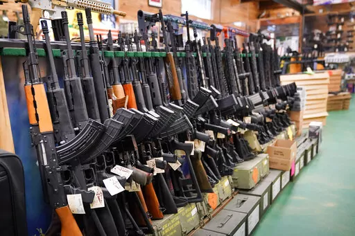 Semi-automatic rifles are displayed at Coastal Trading and Pawn, Monday, July 18, 2022, in Auburn, Maine. President Joe Biden and the Democrats have become increasingly emboldened in pushing for stronger gun control. The Democratic-led House passed legislation in July to revive a 1990s-era ban on certain semi-automatic guns, with Biden’s vocal support. And the president pushed the weapons ban nearly everywhere that he campaigned this year. (AP Photo/Robert F. Bukaty, File)