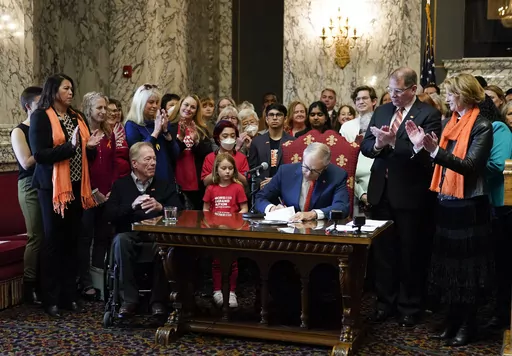 Washington Gov. Jay Inslee signs House Bill 1240, which prohibits the manufacture, importation, distribution and sale of semi-automatic assault-style weapons in the state, April 25, 2023, at the state Capitol in Olympia, Wash. A U.S. judge on Tuesday, June 6, rejected a request to block a new Washington state law banning the sale of certain semi-automatic rifles, one of three measures recently signed by Inslee in an effort to reduce gun violence. (AP Photo/Lindsey Wasson, File)