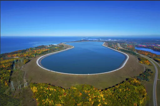 This undated photo provided by Consumers Energy shows an aerial view of the Ludington Pumped Storage Plant near Ludington, Mich. The plant generates electricity by pumping water from Lake Michigan to a reservoir on top of a bluff, then releasing it through giant turbines as needed. Advocates of pumped storage call such facilities the "world's largest batteries." (AP Photo/Consumers Energy)