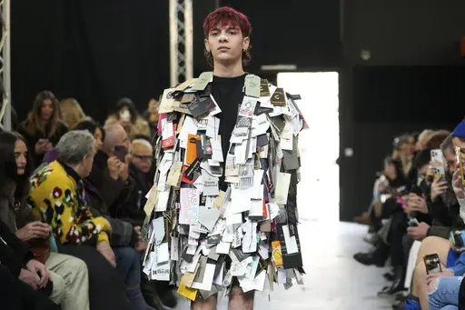 A model wears a creation part of the men's and Women's Simon Cracker Fall-Winter 2025-2026 collection, that was presented in Milan, Italy, Sunday, Jan. 19, 2025. (AP Photo/Luca Bruno)
