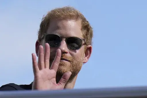 Britain's Prince Harry, the Duke of Sussex, waves during the Formula One U.S. Grand Prix auto race at Circuit of the Americas, on Oct. 22, 2023, in Austin, Texas. (AP Photo/Nick Didlick, File)