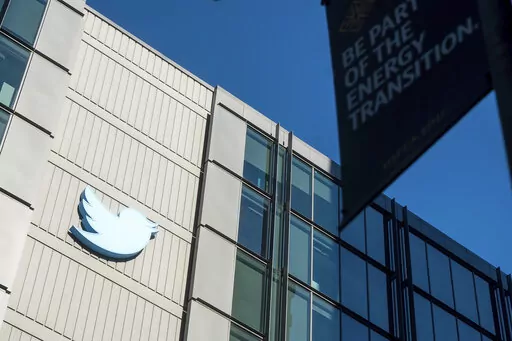 A Twitter logo hangs outside the company's San Francisco offices on Nov. 1, 2022. A top European Union official warned Elon Musk on Wednesday Nov. 30, 2022 that Twitter needs to beef up measures to protect users from hate speech, misinformation and other harmful content to avoid violating new rules that threaten tech giants with big fines or even a ban in the 27-nation bloc. (AP Photo/Noah Berger, File)